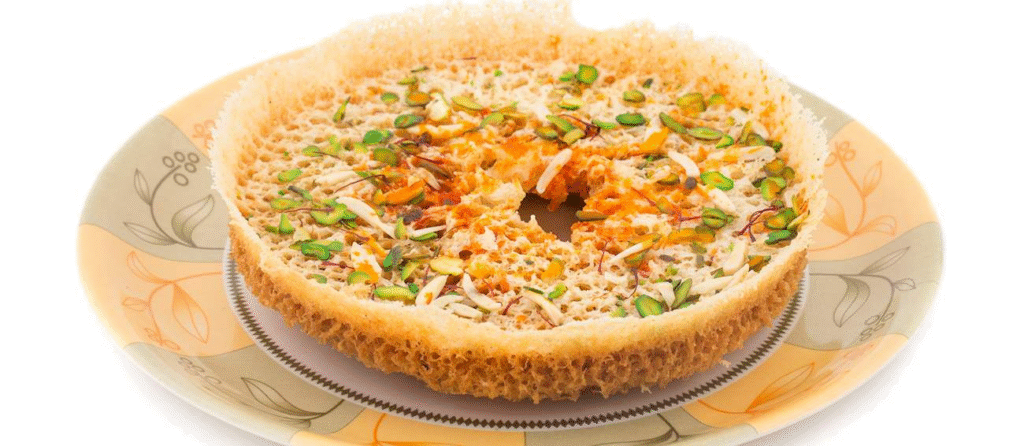 The intricate honeycomb texture of Ghevar, a delicate sweet that defines the festive spirit of a Rajasthan culinary journey.